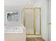 Bathroom features a white tub and shower with gold frame, and a window at 3609 Indigo Creek Nw Trl, Kennesaw, GA 30144