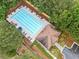 Aerial view of a community pool and pool house surrounded by lush green trees at 3609 Indigo Creek Nw Trl, Kennesaw, GA 30144
