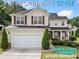 Charming two-story home featuring manicured landscaping, a two-car garage, and inviting front porch at 3609 Indigo Creek Nw Trl, Kennesaw, GA 30144