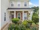 Welcoming front porch with stone accents, white columns, and lush landscaping at 3609 Indigo Creek Nw Trl, Kennesaw, GA 30144