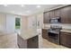 Spacious kitchen with a granite island, stainless appliances, and sliding glass doors to the backyard at 3609 Indigo Creek Nw Trl, Kennesaw, GA 30144