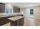Large kitchen features granite countertops, stainless steel sink, and access to backyard through sliding glass doors at 3609 Indigo Creek Nw Trl, Kennesaw, GA 30144