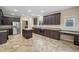 Gourmet kitchen with dark wood cabinets, granite countertops, stainless steel appliances, and a functional center island at 3609 Indigo Creek Nw Trl, Kennesaw, GA 30144
