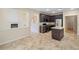 View of a kitchen with brown cabinets, stainless steel appliances, granite countertops, and a tiled floor at 3609 Indigo Creek Nw Trl, Kennesaw, GA 30144