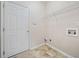Functional laundry room with shelving and tiled flooring at 3609 Indigo Creek Nw Trl, Kennesaw, GA 30144
