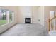 Bright living room with a fireplace, large windows, and neutral carpet, creating a warm and inviting space at 3609 Indigo Creek Nw Trl, Kennesaw, GA 30144