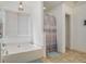 Bright bathroom with a soaking tub, tile floors, a large window and a shower with curtain at 493 Whaleys Lake Dr, Jonesboro, GA 30238