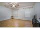 Spacious bedroom with hardwood floors, neutral walls, two windows, a ceiling fan and minimal furnishings at 493 Whaleys Lake Dr, Jonesboro, GA 30238