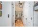 Bright hallway with light wood floors and white walls, with a view of the front door at the end at 493 Whaleys Lake Dr, Jonesboro, GA 30238