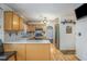 Functional kitchen with wood cabinets, stainless steel appliances, light countertops, and hardwood flooring at 493 Whaleys Lake Dr, Jonesboro, GA 30238