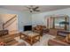 Inviting living room features classic furniture, a ceiling fan, wood floors and an open archway to another room at 493 Whaleys Lake Dr, Jonesboro, GA 30238