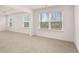 Bright bedroom with multiple windows offering ample natural light and neutral carpeting at 1179 Blue Juniper Cir, Loganville, GA 30052