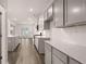 Open-concept kitchen featuring stainless appliances, stone countertops, and ample cabinet space at 1179 Blue Juniper Cir, Loganville, GA 30052