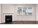 Living room featuring a fireplace and bright natural light at 1179 Blue Juniper Cir, Loganville, GA 30052