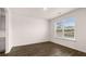 Bright room with dark hardwood floors and a large window at 1179 Blue Juniper Cir, Loganville, GA 30052