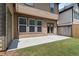 Concrete back patio with double doors and a grassy yard provides a relaxing outdoor space at 1239 Grampian Pass # 11, Marietta, GA 30008
