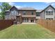 The backyard features a spacious lawn and a wooden fence, perfect for outdoor activities and privacy at 1239 Grampian Pass # 11, Marietta, GA 30008