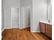 Bathroom with hardwood floors, double-door closet, and wooden vanity with sink at 1239 Grampian Pass # 11, Marietta, GA 30008