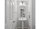 Cozy half bathroom with modern fixtures and a pedestal sink at 1239 Grampian Pass # 11, Marietta, GA 30008