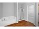 Bright bathroom featuring a soaking tub and a separate glass-enclosed shower at 1239 Grampian Pass # 11, Marietta, GA 30008