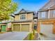 Charming two-story townhome with a brick and siding exterior, plus a two-car garage and lovely landscaping at 1239 Grampian Pass # 11, Marietta, GA 30008