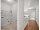 Upstairs hallway with laundry, featuring hardwood floors and natural light at 1239 Grampian Pass # 11, Marietta, GA 30008