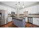 Modern kitchen with stainless steel appliances, island and stylish backsplash at 1239 Grampian Pass # 11, Marietta, GA 30008