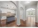 Open kitchen featuring an island, white cabinets, and hardwood floors at 1239 Grampian Pass # 11, Marietta, GA 30008