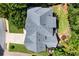 Aerial view showcasing a home's architectural roofline and manicured landscaping, nestled among lush green trees at 220 Webley Ln, Alpharetta, GA 30022