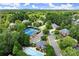 Aerial shot highlighting community amenities with mature trees; pool, tennis courts, and other amenities within a residential area at 220 Webley Ln, Alpharetta, GA 30022