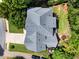 Aerial view of a home featuring a gray roof, landscaped yard, and a long driveway at 220 Webley Ln, Alpharetta, GA 30022