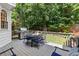 Inviting back deck with dining table and lush greenery for outdoor relaxation at 220 Webley Ln, Alpharetta, GA 30022