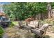 Backyard with patio seating, deck area, and mature trees for shade and privacy at 220 Webley Ln, Alpharetta, GA 30022