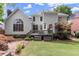 Inviting backyard showcasing a spacious deck, lush lawn, and mature landscaping, ideal for outdoor enjoyment at 220 Webley Ln, Alpharetta, GA 30022