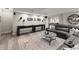 Basement rec room with a sectional sofa, shuffleboard table, and wood-look floors at 220 Webley Ln, Alpharetta, GA 30022