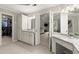 Bright primary bathroom with double granite vanity, tiled floors, and walk-in closet access at 220 Webley Ln, Alpharetta, GA 30022