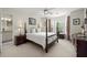 Light-filled bedroom featuring a four-poster bed, neutral carpet, and bay window at 220 Webley Ln, Alpharetta, GA 30022