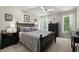 Beautiful bedroom with a dark wooden bed frame, neutral carpet, and large window at 220 Webley Ln, Alpharetta, GA 30022