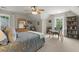 Comfortable bedroom with a ceiling fan, two windows with curtains, desk, and bookshelf at 220 Webley Ln, Alpharetta, GA 30022