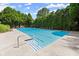 Large, sparkling pool with neatly arranged lounge chairs offering a luxurious outdoor experience at 220 Webley Ln, Alpharetta, GA 30022