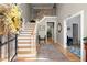 Bright foyer boasts wood floors, staircase to the second level, and entry to various rooms at 220 Webley Ln, Alpharetta, GA 30022
