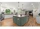 Gourmet kitchen featuring a large center island, pendant lighting, and state-of-the-art appliances at 220 Webley Ln, Alpharetta, GA 30022