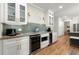 Modern kitchen with granite counters, wine cooler, stainless appliances, and hardwood floors at 220 Webley Ln, Alpharetta, GA 30022