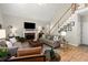 Cozy living room featuring a brick fireplace, hardwood floors, and ample seating at 220 Webley Ln, Alpharetta, GA 30022