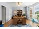 Well-lit home office featuring hardwood floors, large windows, and a built-in bookcase at 220 Webley Ln, Alpharetta, GA 30022