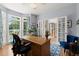 Spacious home office with French doors, hardwood flooring, and a comfortable seating area at 220 Webley Ln, Alpharetta, GA 30022
