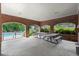 Brick pool-house with tables, overlooks pool deck area with chairs, offering a relaxing community space at 220 Webley Ln, Alpharetta, GA 30022