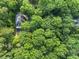 Aerial view of a home nestled in a lush canopy of green trees, creating a private retreat at 127 Roe Hampton Ln Ln, Stone Mountain, GA 30087