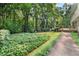 Lush backyard featuring a well-maintained lawn, mature trees, and a charming deck at 127 Roe Hampton Ln Ln, Stone Mountain, GA 30087