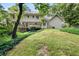 Expansive backyard featuring a lush lawn, mature trees, and a multi-level deck for outdoor enjoyment at 127 Roe Hampton Ln Ln, Stone Mountain, GA 30087